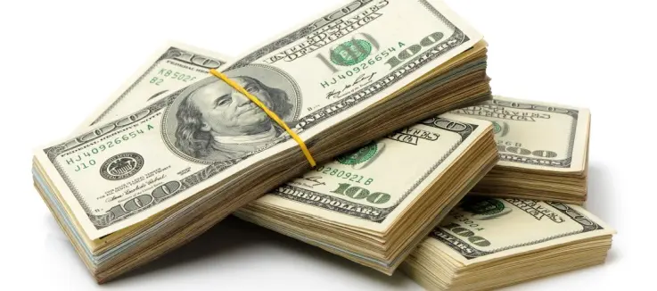 a pile of wads of 100 dollar bills